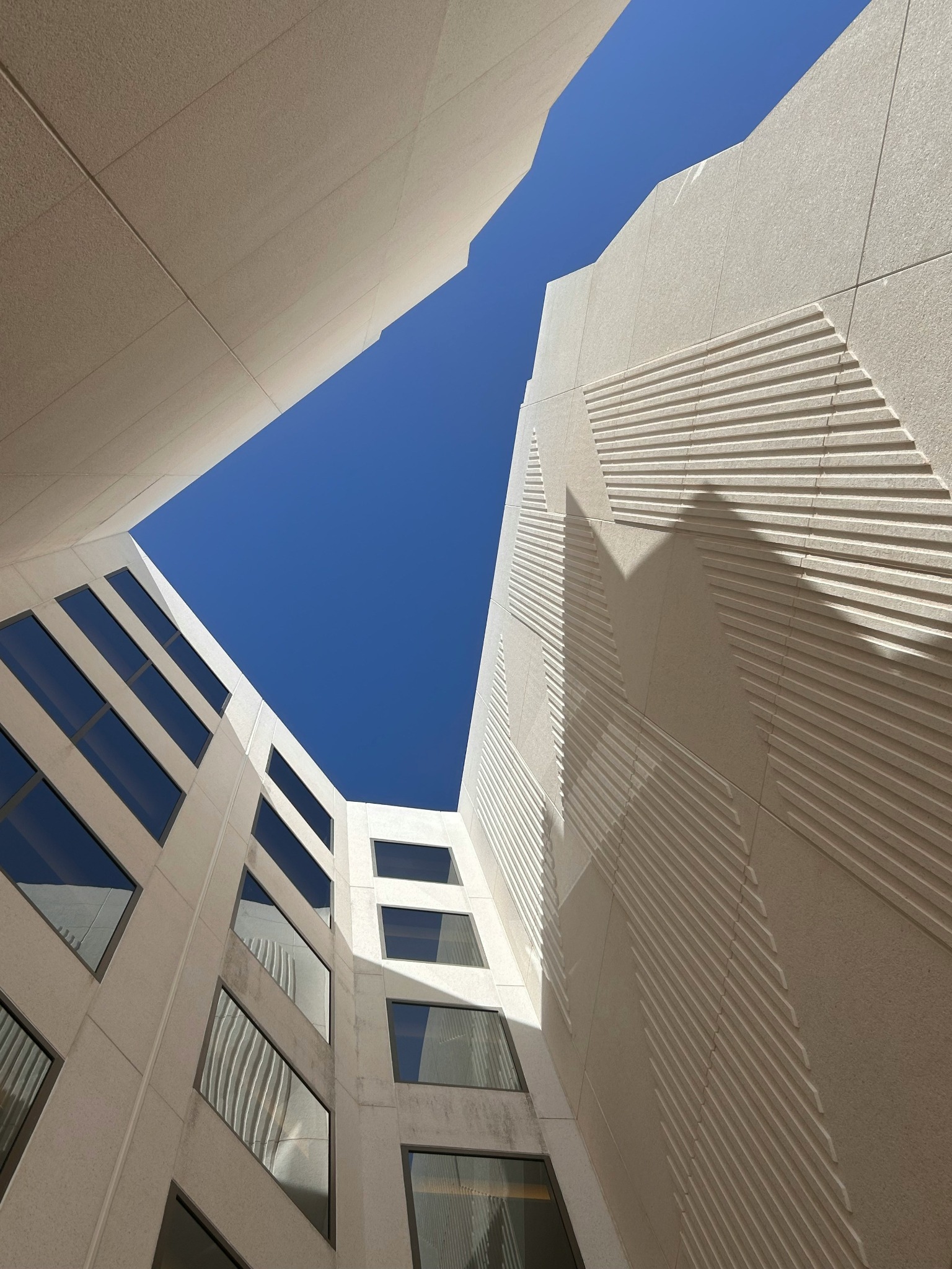 Sunlit architectural courtyard with strong geometric forms